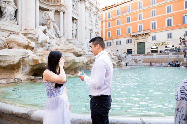 Romantic surprise wedding proposal at the Trevi Fountain in Rome