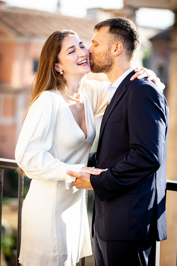 Elegant newly-engaged couple smiling during their engagement photo shoot on the Capitoline Hill in Rome