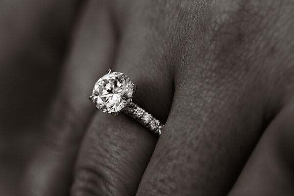 Black and white close-up of an engagement ring with a beautiful diamond