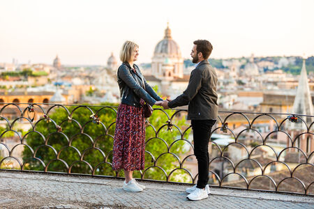Couple holding hands at the Terrazza Belvedere at sunset at the Pincio Gardens in Rome
