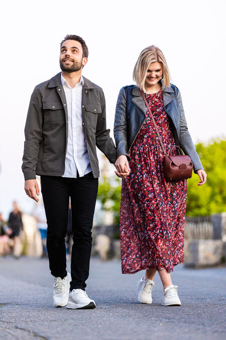 newly-engaged couple walking hand in hand at the Pincio Gardens in Rome
