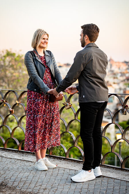 Couple holding hands during their surprise proposal on the Terrazza Belvedere in Rome