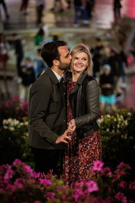 Newly-engaged couple surrounded by flowers on the Spanish Steps during their proposa photo session in Rome