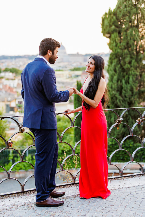 Beautiful couple on the Terrazza Belvedere at sunset during their surprise proposal photo session in Rome