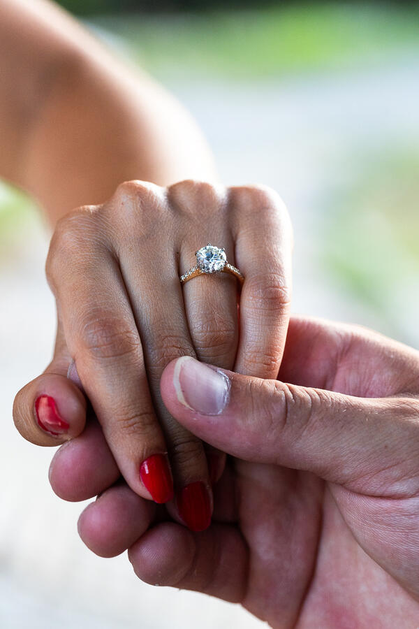 Close-up of fiancée's hand with a beautiful diamond engagement ring on
