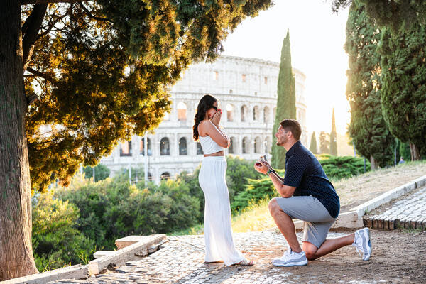 Surprise wedding proposal on the Oppian Hill overlooking the Colosseum at sunset