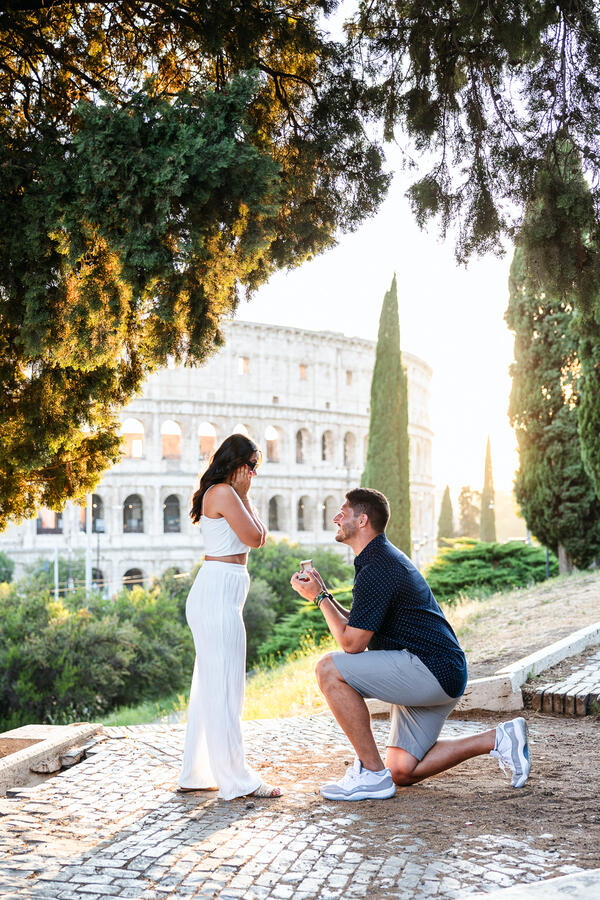 Romantic surprise marriage proposal on the Oppian Hill with a view to the Colosseum at sunset