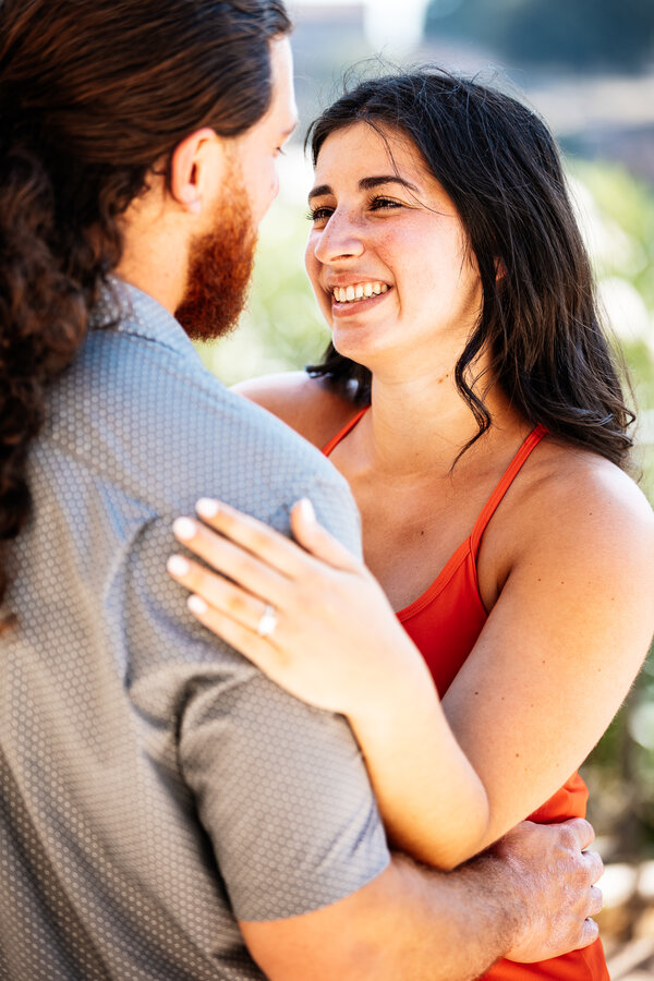 Fiancée smiling at her finace during their engagement photo session at the Giardinetto del Monte Oppio in Rome