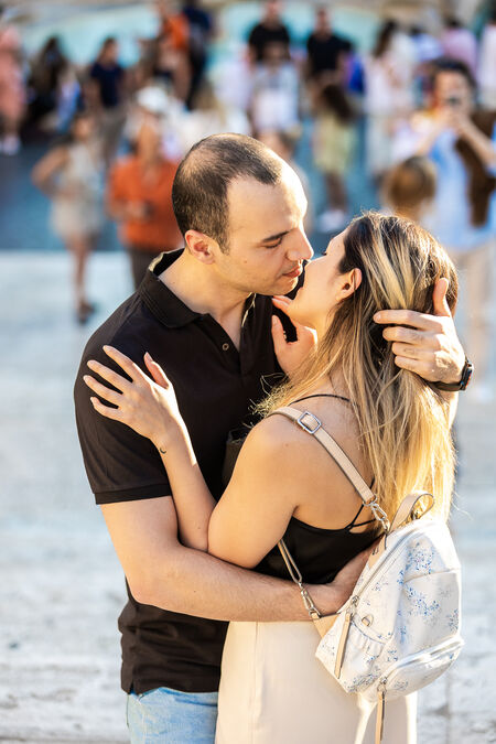 Newly-engaged couple on the Spanish Steps during their surprise proposal photo shoot in Rome