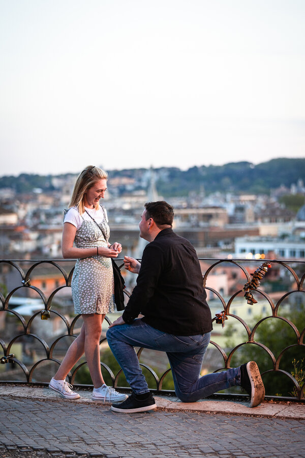 Happy couple during their surprise marriage proposal on the Terrazza Belvedere at sunset