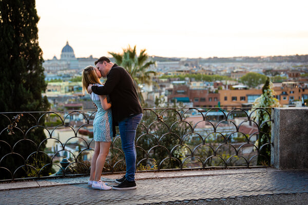 Newly-engaged couple kissing in Rome during the their surprise proposal photoshoot