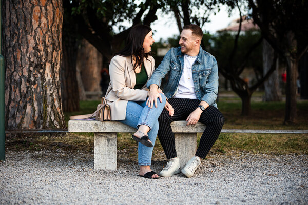 Couple smiling during their proposal photo shoot at the Orange Garden