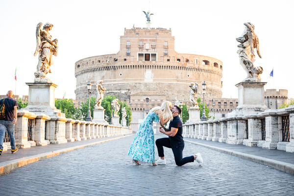 Couple kissing during their wedding proposal photoshoot at sunrise in Rome