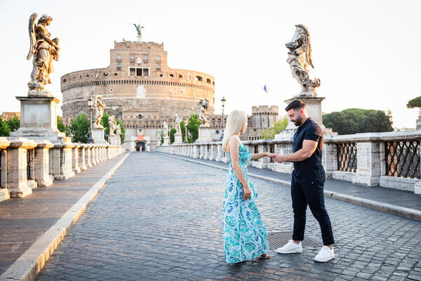 Newly-engaged fiancé putting on the engagement ring during a wedding proposal shoot in Rome