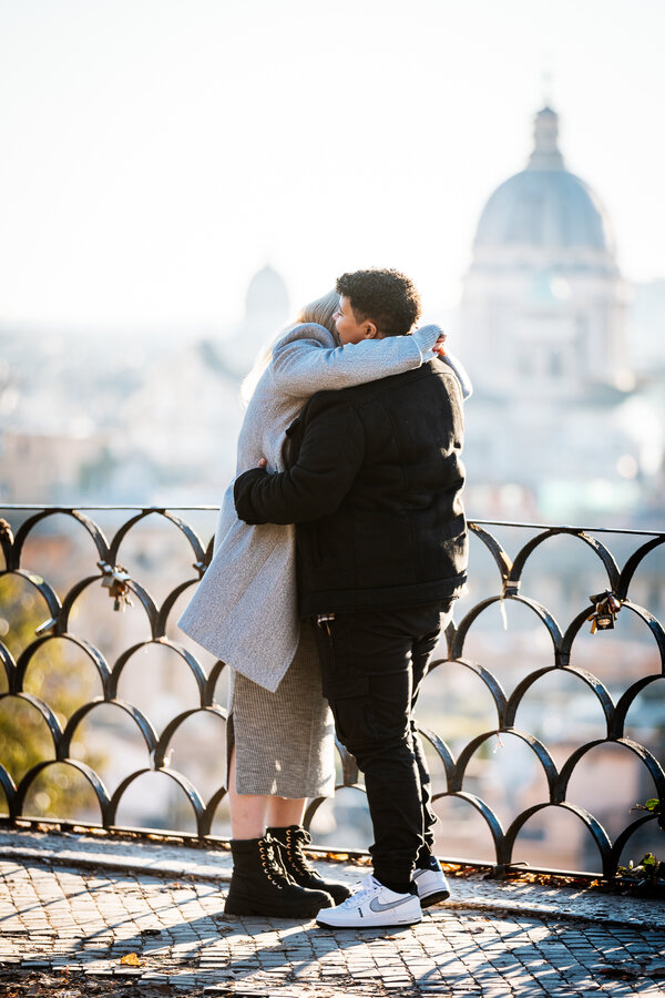 Newly-engaged couple in a tender embrace at the Pincio Gardens in Rome