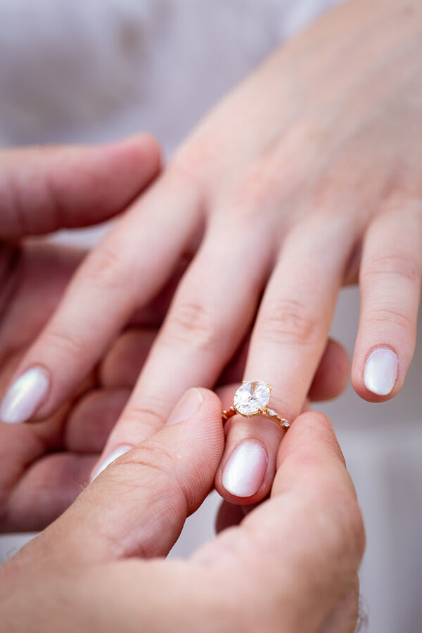 Diamond engagement ring on the fiancée's finger during a surprise proposal photo shoot in Rome