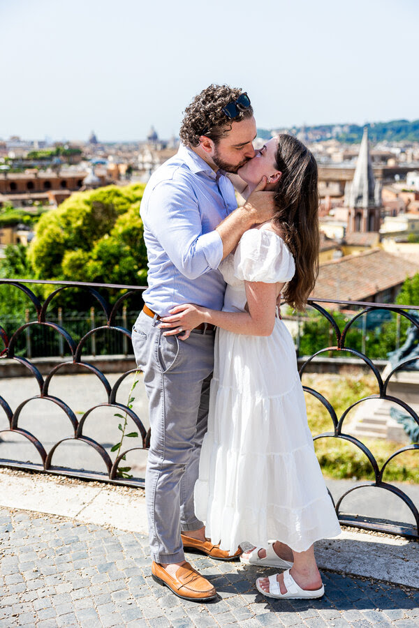 newly-engaged couple kissing during their surprise wedding proposal in Rome