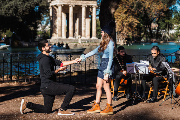 Romantic surprise wedding proposal by the pond and with a string quartet in Villa Borghese