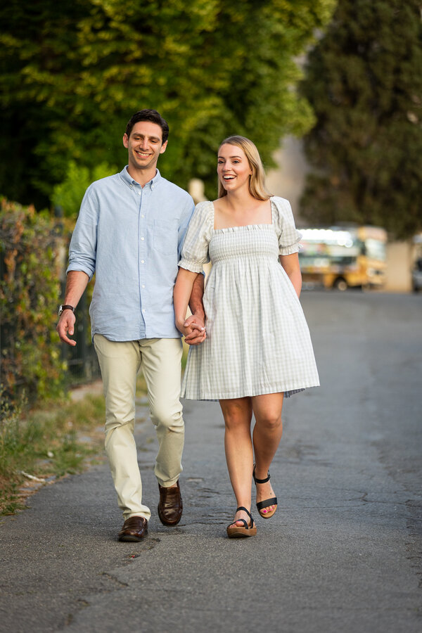 Newly-engaged couple walking on the Pincian Hill during their surprise proposal photo session at sunset