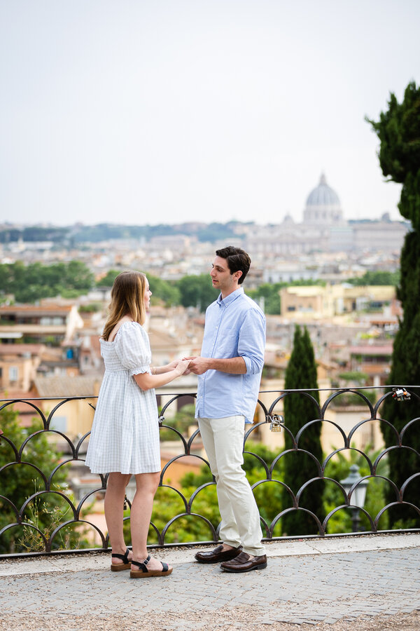 Couple on the Terrazza Belvedere against the Saint Peter's in the background at sunset