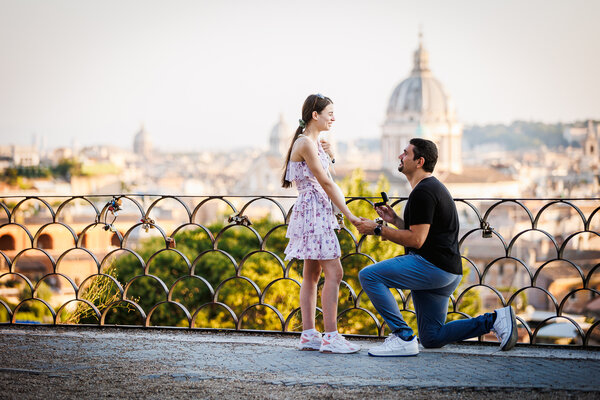 Romantic surprise marriage proposal on the Terrazza Belvedere in Rome at sunset