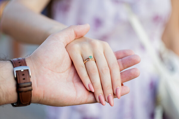 Fiance holding his finacée's hands showing her engagement ring during their engagement photo shoot in Rome