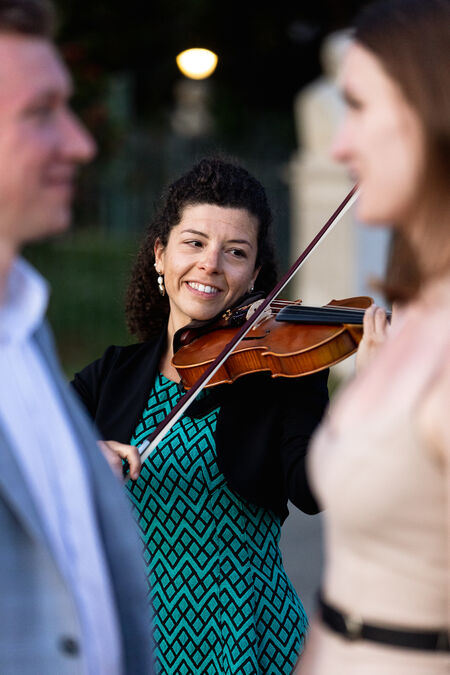 Violinist playing during a surprise proposal at the Pincio Gardens in Rome