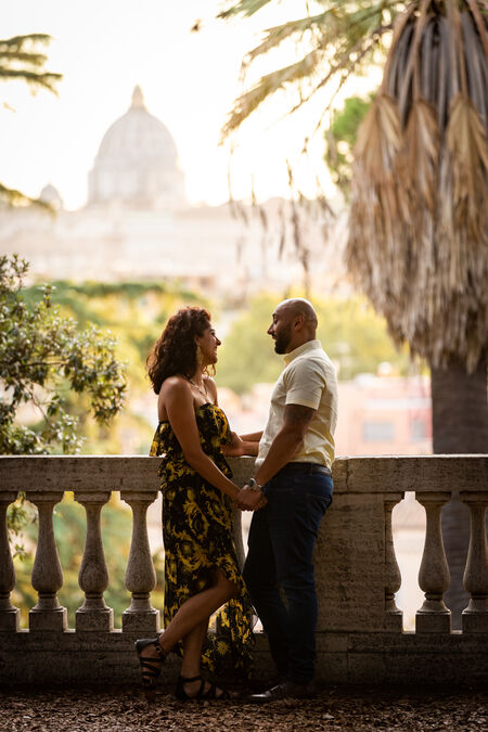Romantic shot in a warm light of couple with the Vatican in the background