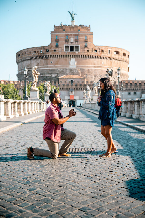 Surprise wedding proposal on Castel Sant'Angelo Bridge on a beautiful day in Rome