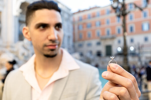 Guy holding the engagement ring of his proposal in Rome