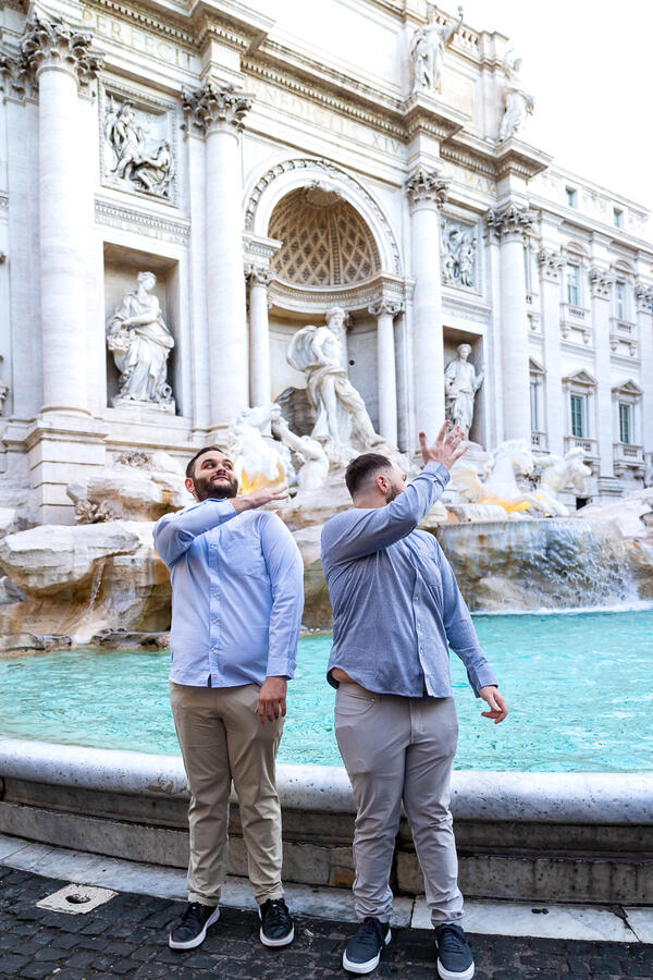 Couple tossing their coins into the Trevi Fountain