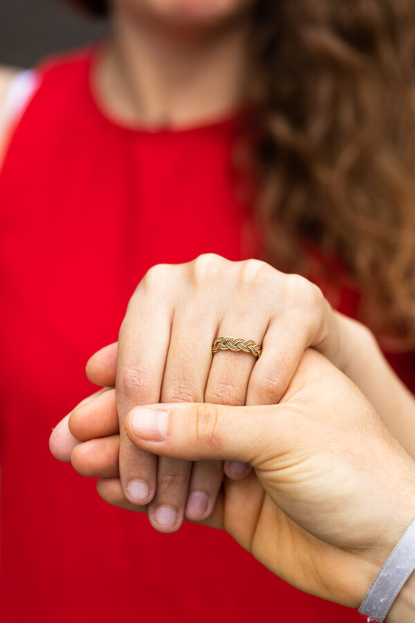 Holding fiancée's hand with engagement ring on during surprise proposal photoshoot in Rome