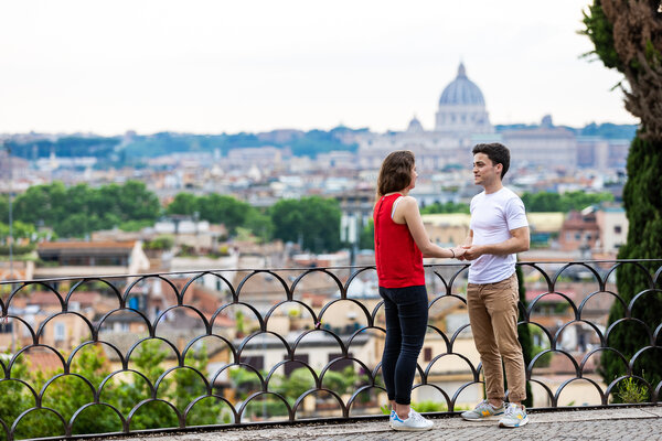 Couple moments before their Surprise marriage proposal in Rome on the Terrazza Belvedere with the Vatican in the background