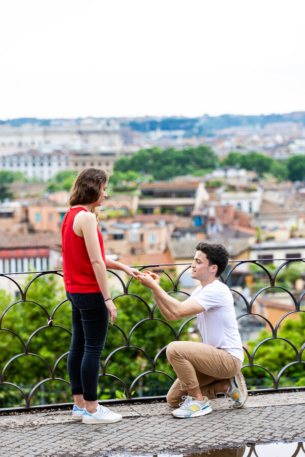 Putting on the engagement ring during Surprise wedding proposal in Rome on the Terrazza Belvedere