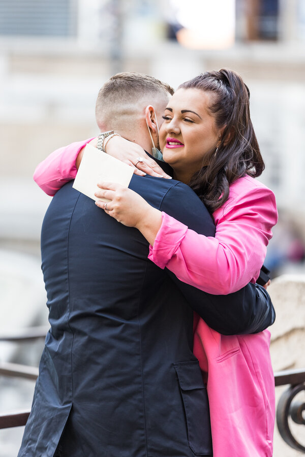 Newly-Engaged couple hugging during their wedding proposal at the Trevi Fountain in Rome