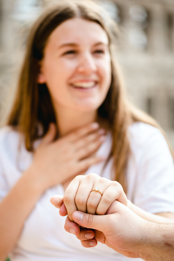 A very happy fiancèe showing off her engagement ring