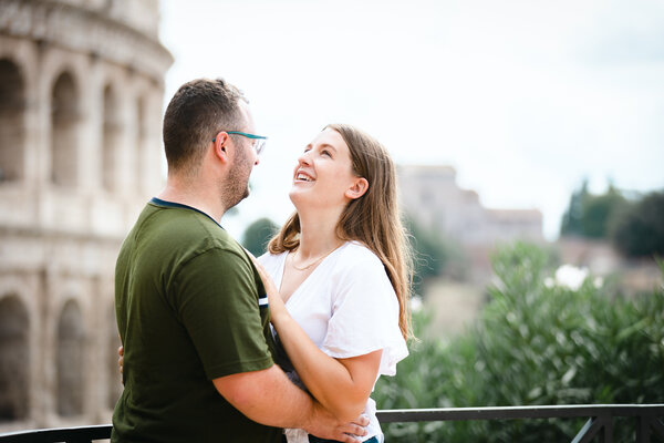 Happy newly-engaged couple with the Colosseum in the background