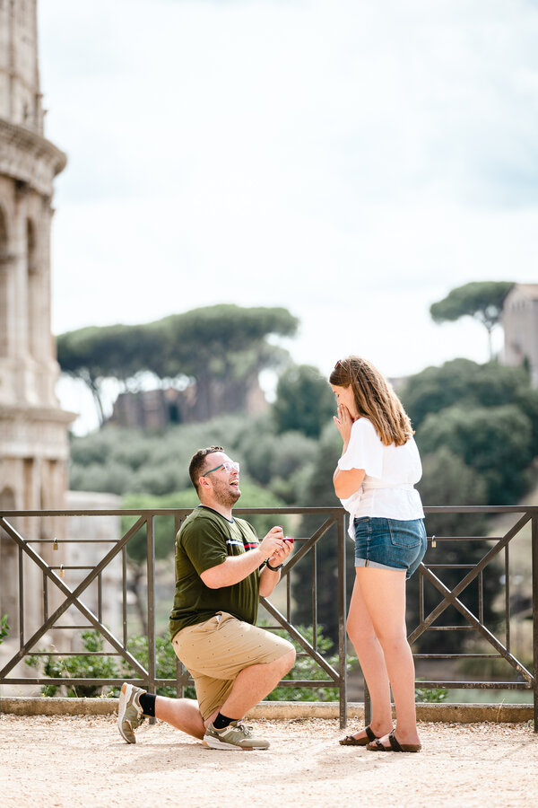 Romantic surprise marriage proposal with a view on the Colosseum in Rome