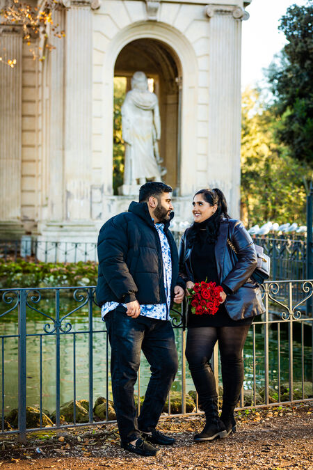 Newly-engaged couple by the pond in Villa Borgese during their surprise wedding proposal photo session in Rome