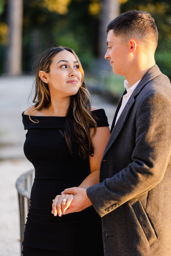 Newly-engaged couple looking in each other's eyes in Villa Celimontana in Rome