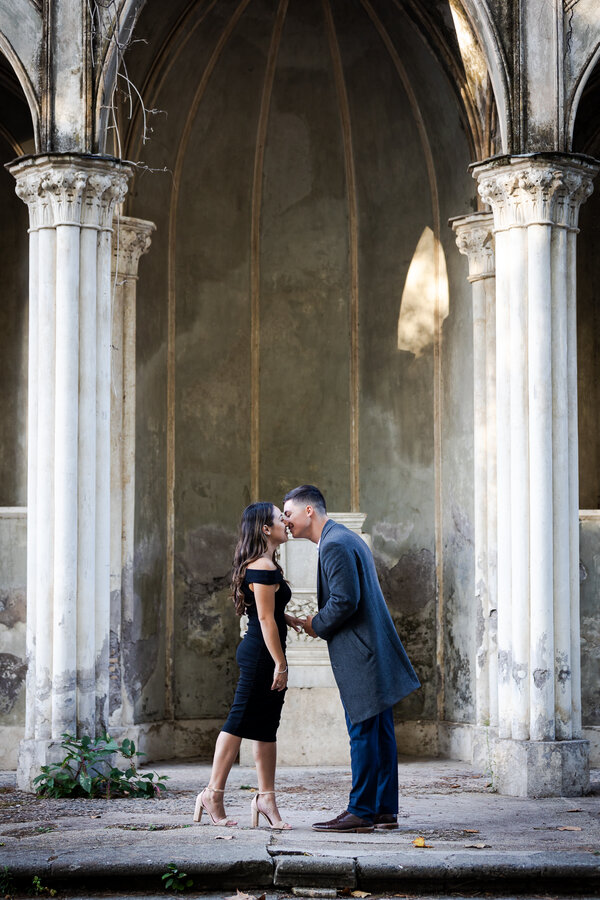 Newly-engaged couple kissing at the Gotic Temple in Rome