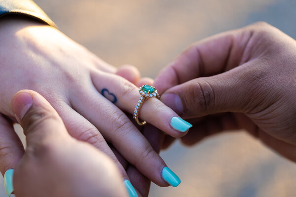 Close-up picture of the engagement ring on the  fiancée's finger