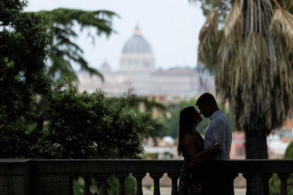 Newly-engaged couple holding each other during the surprise proposal photoshoot in Rome