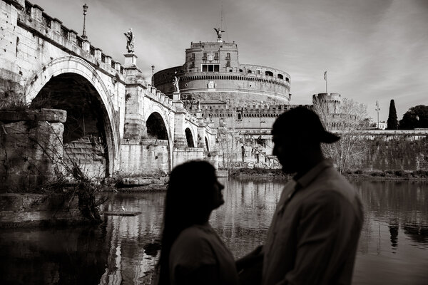 Black and white picture of newly-engaged couple in silhouette with Castel Sant'Angelo in the background