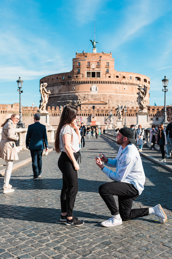 Guy proposing to his girlfriend holding the engagement ringbox during their wedding proposal in Rome