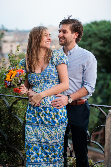 Very happy newly-engaged couple smiling at each other on the Pincian Hill in Rome