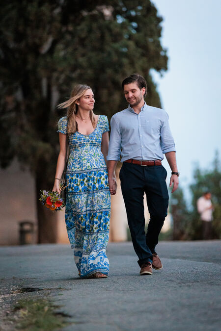 Newly-engaged couple walking on the Pincian Hill during their surprise proposal photo shoot in Rome
