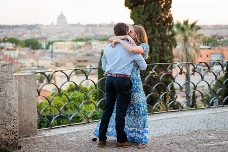 Couple kissing during their surprise proposal photo session on the Terrazza Belvedere