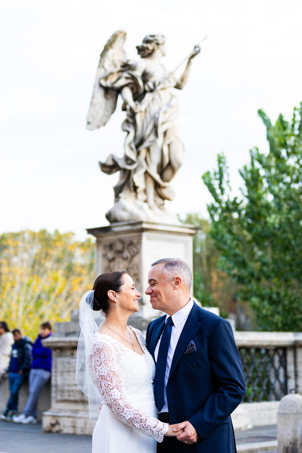 Happy newly-wed couple holding each other during their Sposi Novelli photoshoot in Rome
