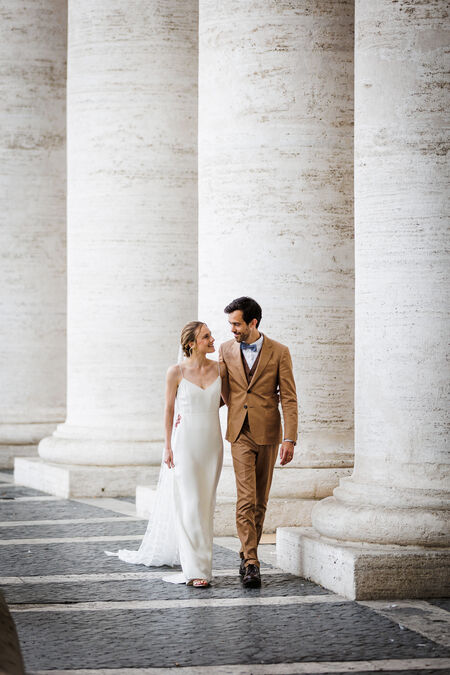 Sposi Novelli couple walking under St. Peter's Square Colonnade